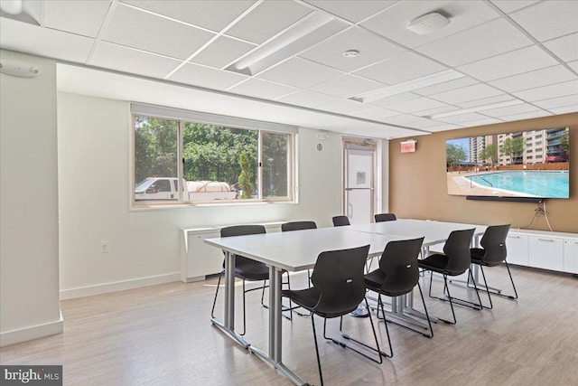 dining area with baseboards and light wood-style floors
