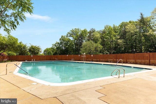 pool with fence and a patio area