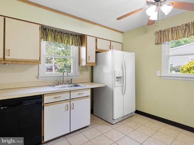 kitchen with light countertops, white fridge with ice dispenser, a sink, a wealth of natural light, and dishwasher