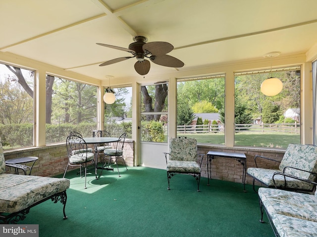 sunroom / solarium with a ceiling fan