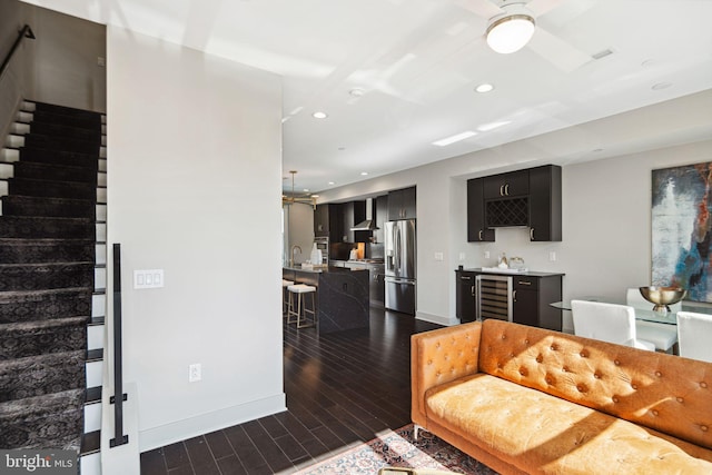 670 N 13th St, Philadelphia, PA 19123 - living area featuring stairway, beverage cooler, dark wood finished floors, bar with sink, and recessed lighting