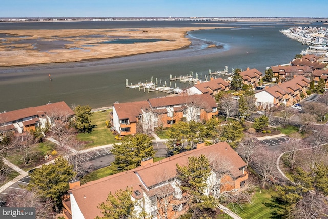 aerial overview of property's location featuring a large body of water and nearby suburban area
