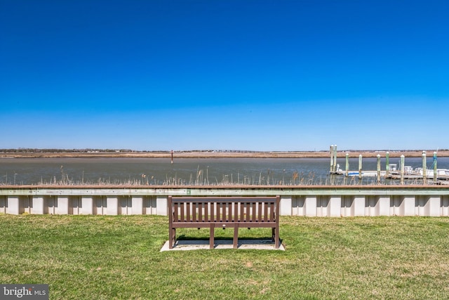 dock area featuring a lawn and a water view