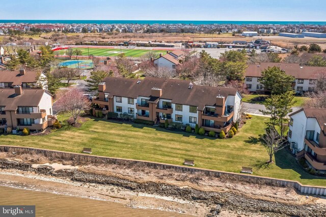 aerial perspective of suburban area with a nearby body of water