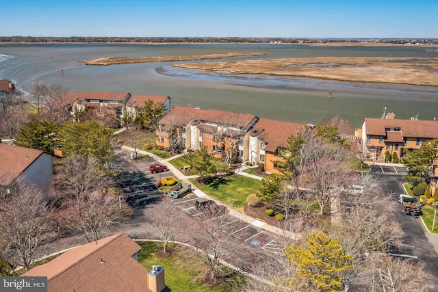 view of property location featuring a large body of water and nearby suburban area