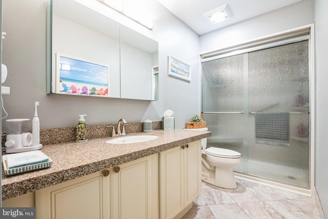 full bathroom with toilet, a shower stall, and vanity