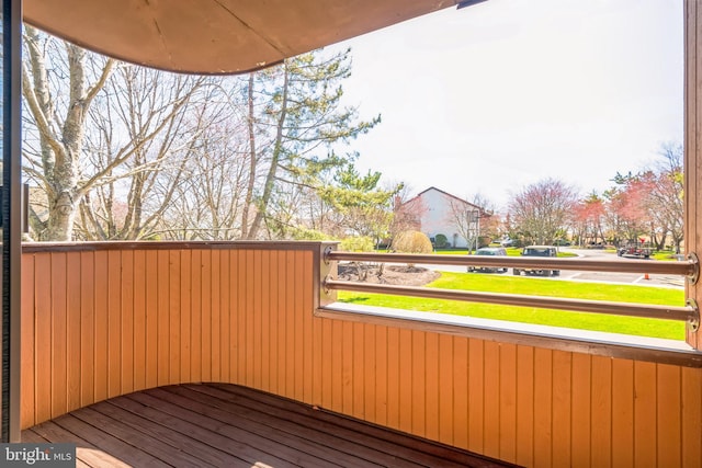wooden deck featuring a yard