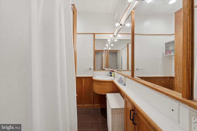 328 S Juniper St, Philadelphia, PA 19107 - bathroom featuring tile patterned floors, wood walls, vanity, and a wainscoted wall