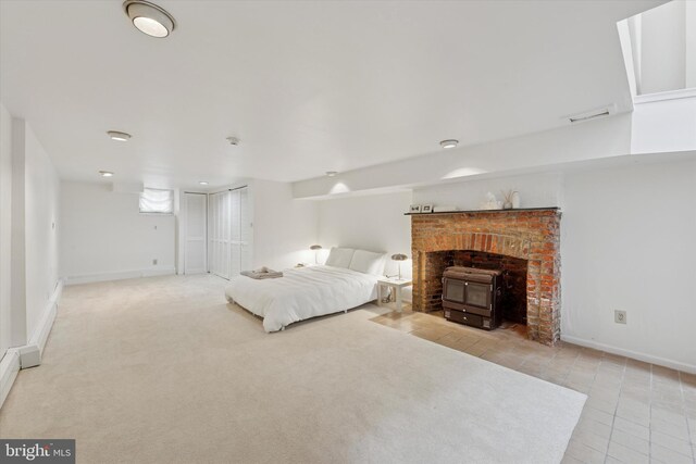 328 S Juniper St, Philadelphia, PA 19107 - tiled bedroom with a wood stove and baseboards