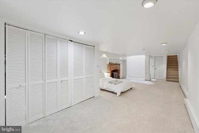 328 S Juniper St, Philadelphia, PA 19107 - bedroom featuring a fireplace, baseboards, a baseboard heating unit, and carpet floors