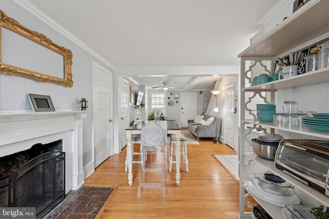 328 S Juniper St, Philadelphia, PA 19107 - dining room with wood finished floors, a ceiling fan, a toaster, a fireplace with flush hearth, and ornamental molding