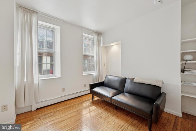 328 S Juniper St, Philadelphia, PA 19107 - living area featuring baseboards, baseboard heating, and wood finished floors