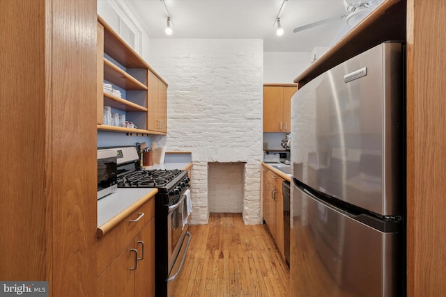328 S Juniper St, Philadelphia, PA 19107 - kitchen with stainless steel appliances, light wood-type flooring, track lighting, light countertops, and a ceiling fan