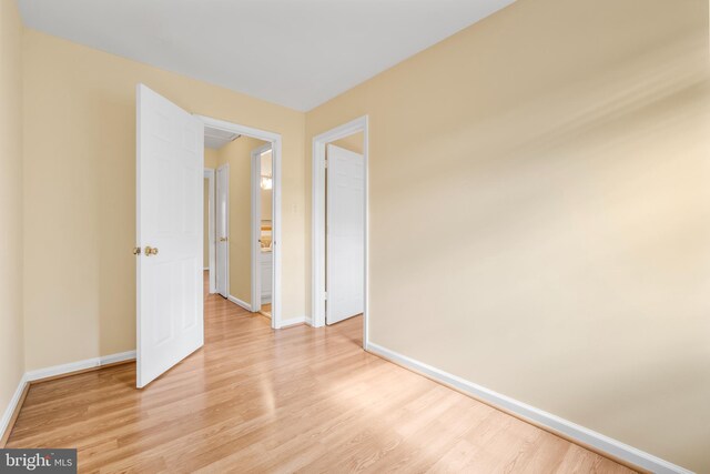 empty room featuring light wood-style floors and baseboards