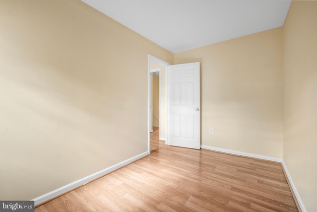 unfurnished room with wood finished floors and baseboards