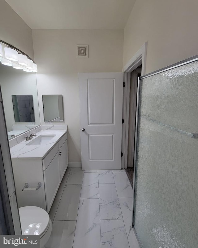 bathroom with vanity, marble finish floor, baseboards, a shower stall, and visible vents
