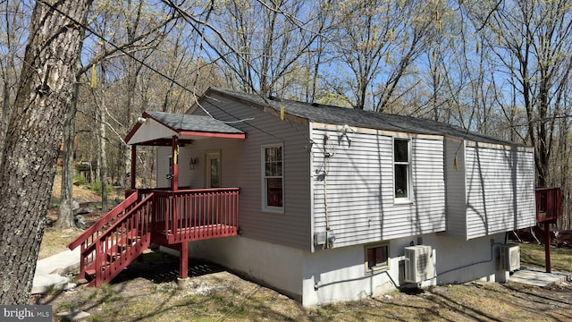 view of home's exterior featuring ac unit and a deck