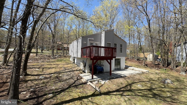 view of home's exterior with a wooden deck