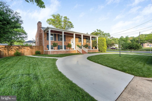 101 Oakmont Ct NE, Vienna, VA 22180 - view of front of property featuring a chimney, a porch, curved driveway, and brick siding