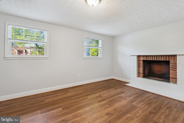 101 Oakmont Ct NE, Vienna, VA 22180 - unfurnished living room with wood finished floors, baseboards, and a fireplace