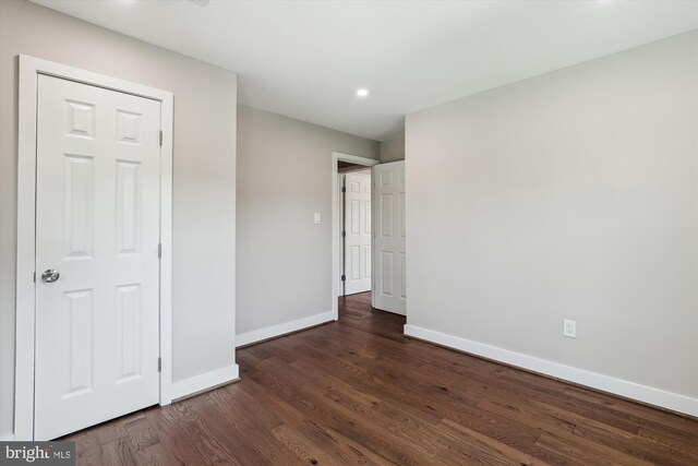 101 Oakmont Ct NE, Vienna, VA 22180 - unfurnished bedroom with baseboards, dark wood-style flooring, and recessed lighting