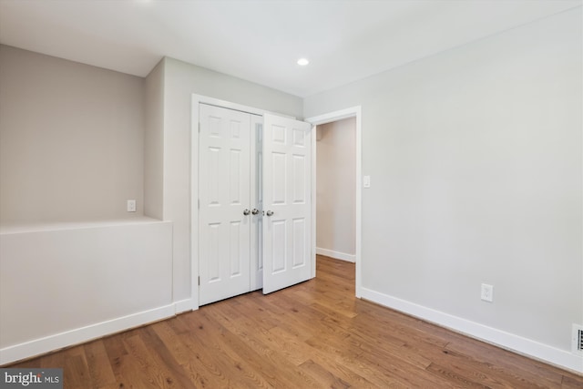 101 Oakmont Ct NE, Vienna, VA 22180 - unfurnished bedroom with baseboards, wood finished floors, recessed lighting, and a closet
