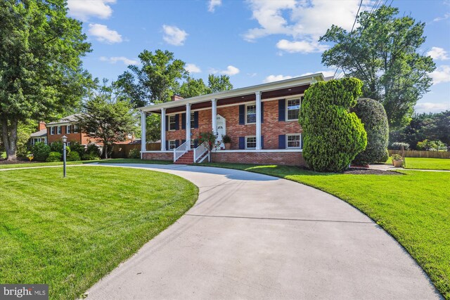 101 Oakmont Ct NE, Vienna, VA 22180 - view of front of property featuring brick siding, curved driveway, and a chimney