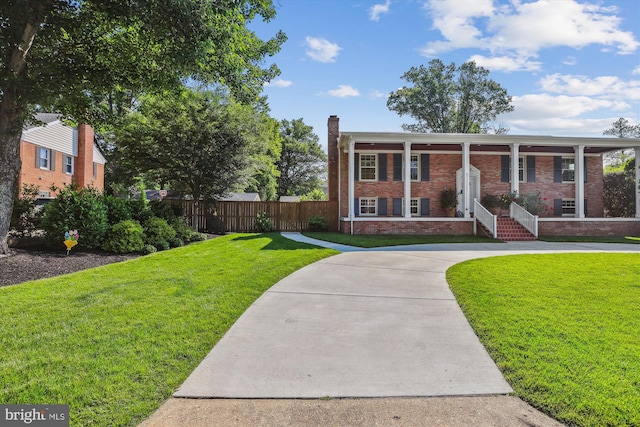 101 Oakmont Ct NE, Vienna, VA 22180 - view of front facade featuring brick siding, a chimney, curved driveway, and a porch