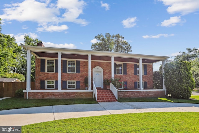 101 Oakmont Ct NE, Vienna, VA 22180 - view of front of property featuring a porch, brick siding, and a chimney