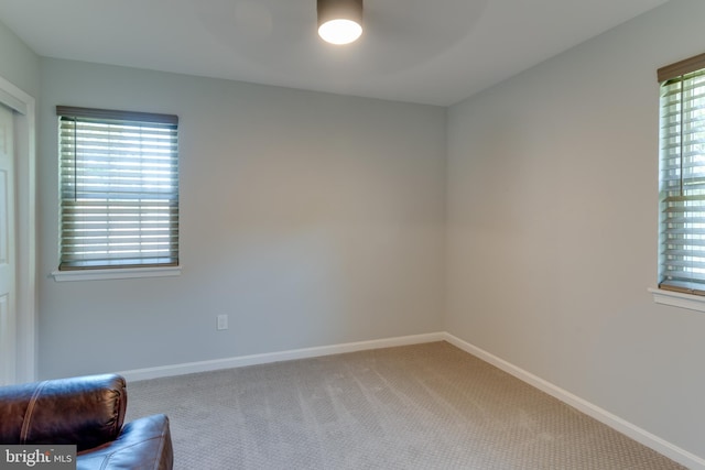spare room featuring ceiling fan, carpet floors, and baseboards