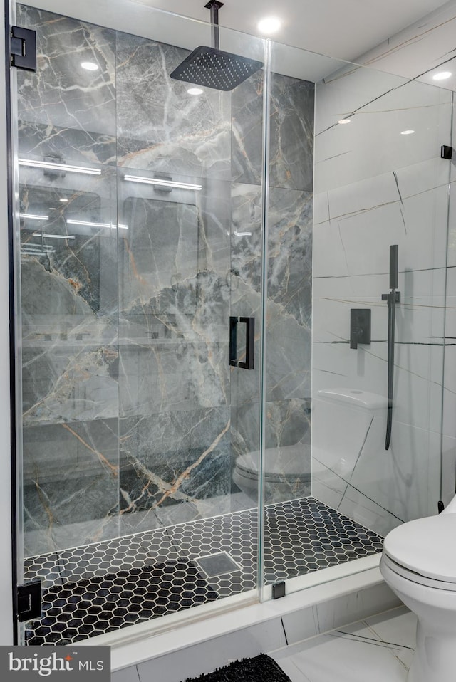 full bath with toilet, a marble finish shower, and marble finish flooring