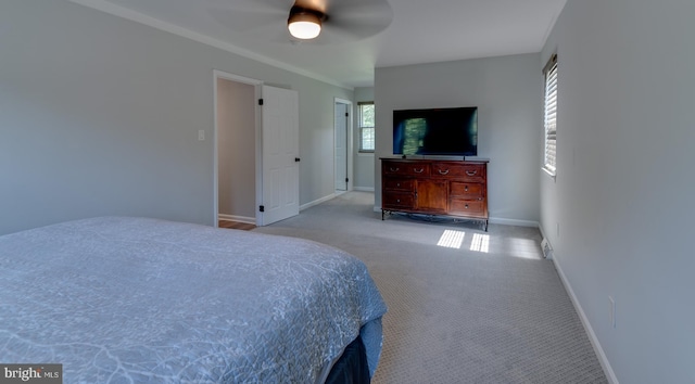 carpeted bedroom featuring baseboards and ceiling fan