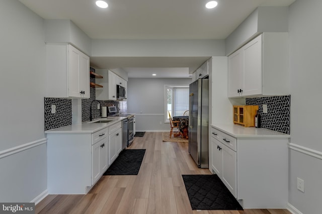 kitchen featuring stainless steel appliances, white cabinetry, open shelves, light countertops, and recessed lighting