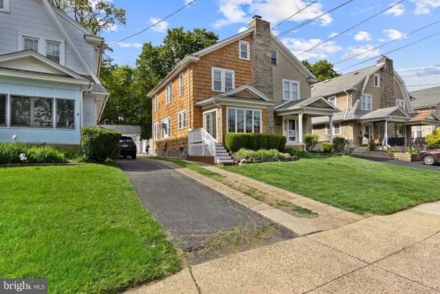 656 Georges Ln, Ardmore, PA 19003 - view of front of home featuring a front lawn, a chimney, and stone siding