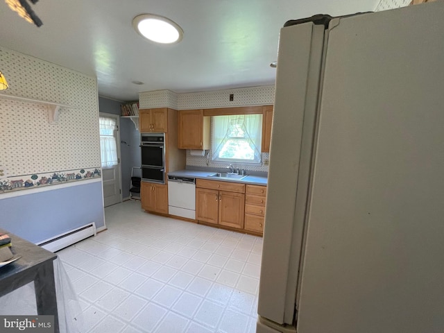 kitchen featuring a sink, white appliances, wallpapered walls, a baseboard radiator, and a warming drawer