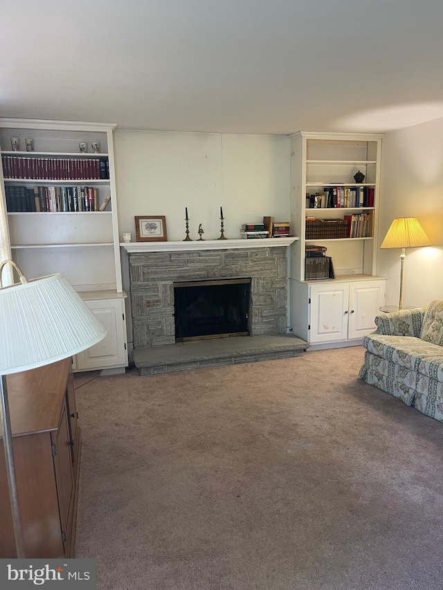 carpeted living room with a fireplace