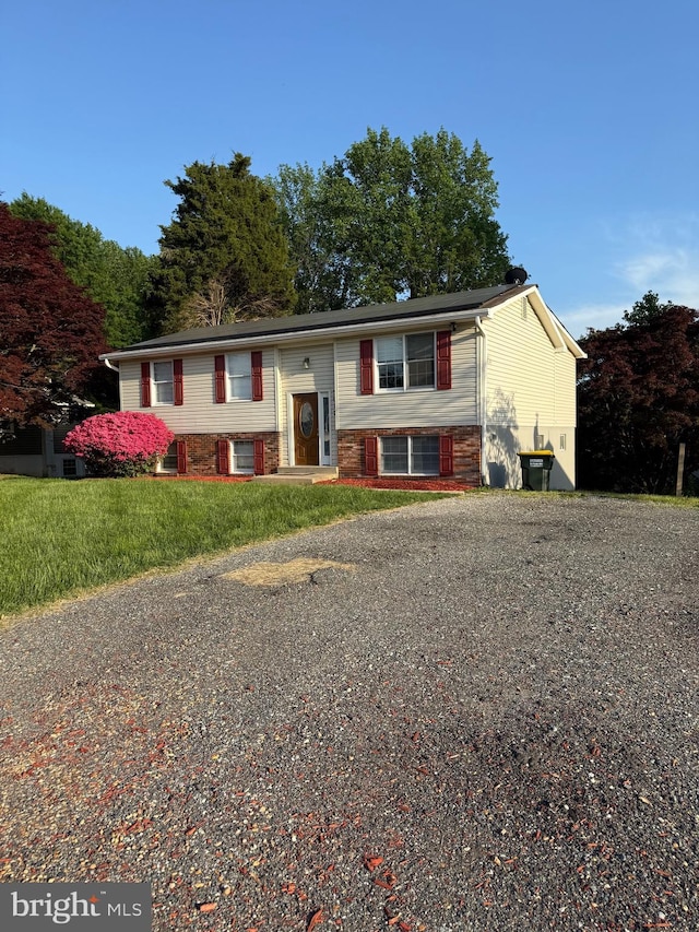 split foyer home with a front lawn