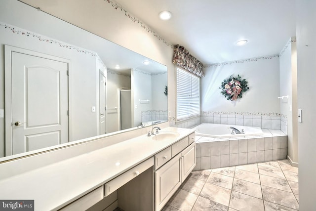 full bathroom featuring recessed lighting, a stall shower, a bath, and vanity