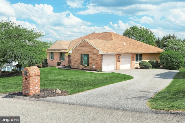 ranch-style house featuring a front lawn, roof with shingles, brick siding, an attached garage, and driveway