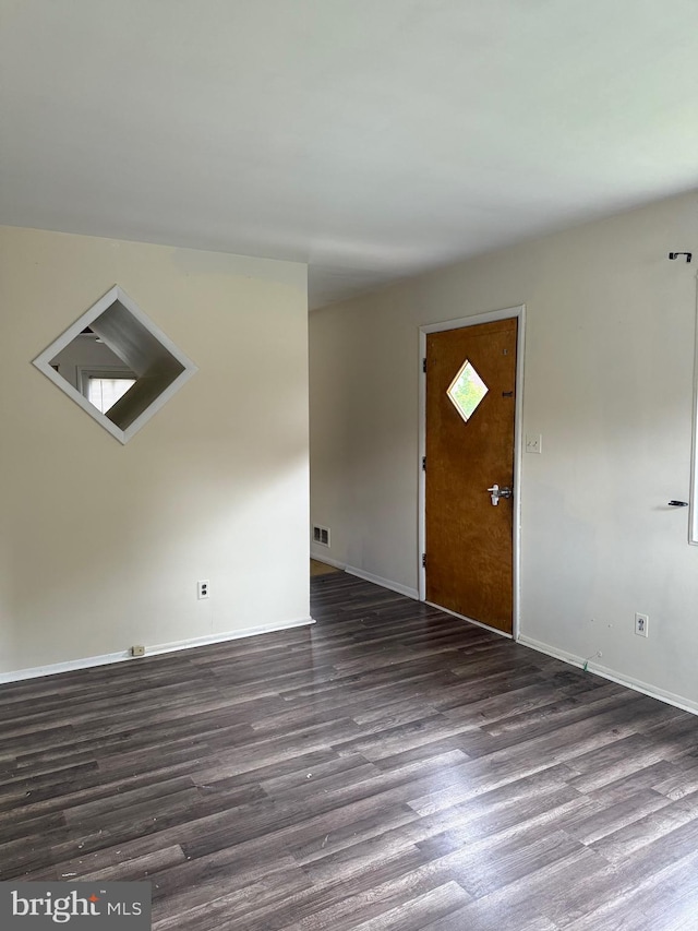 5119 19th St N, Arlington, VA 22207 - unfurnished living room with dark wood-style flooring and baseboards