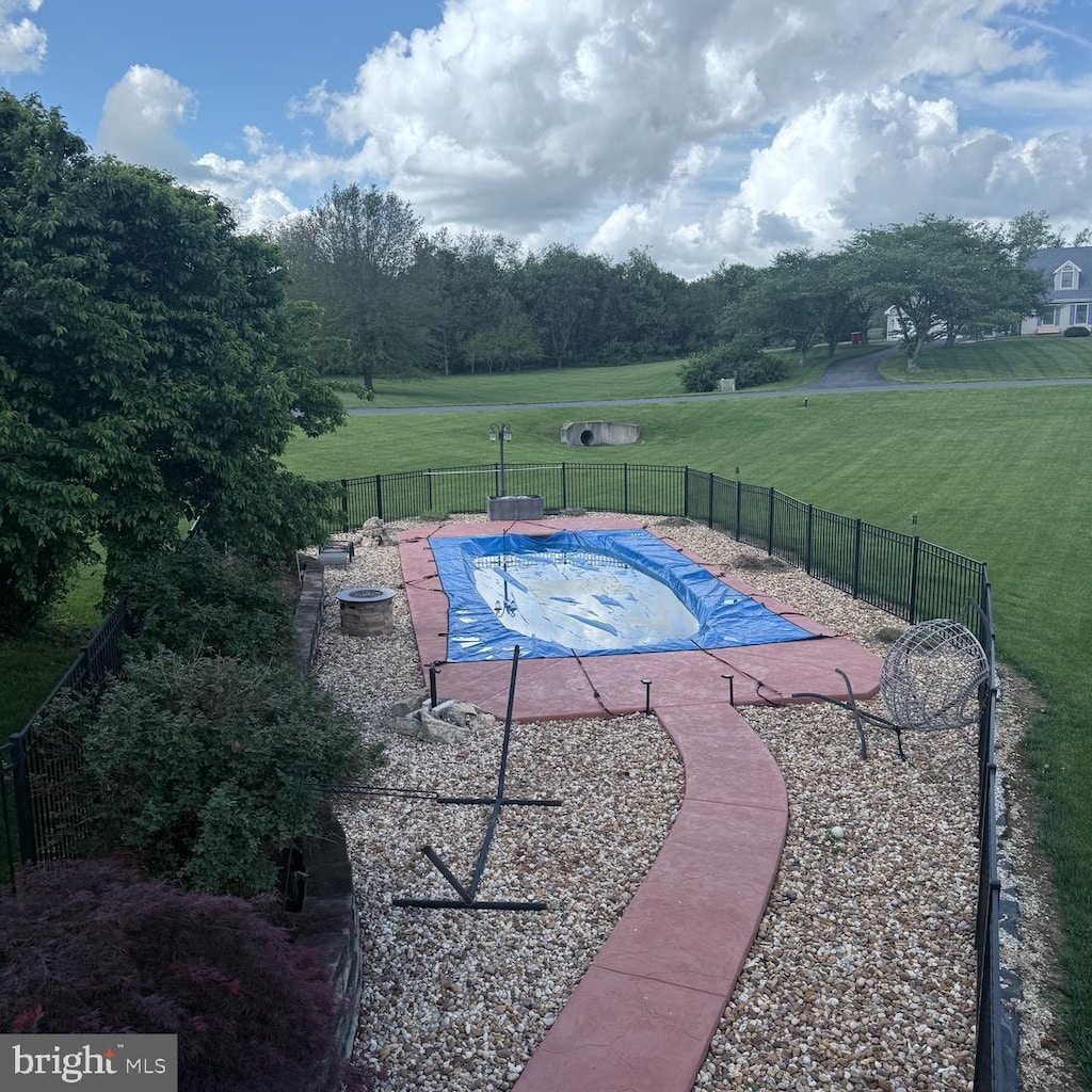 view of swimming pool with fence, a fenced in pool, a yard, and a patio area