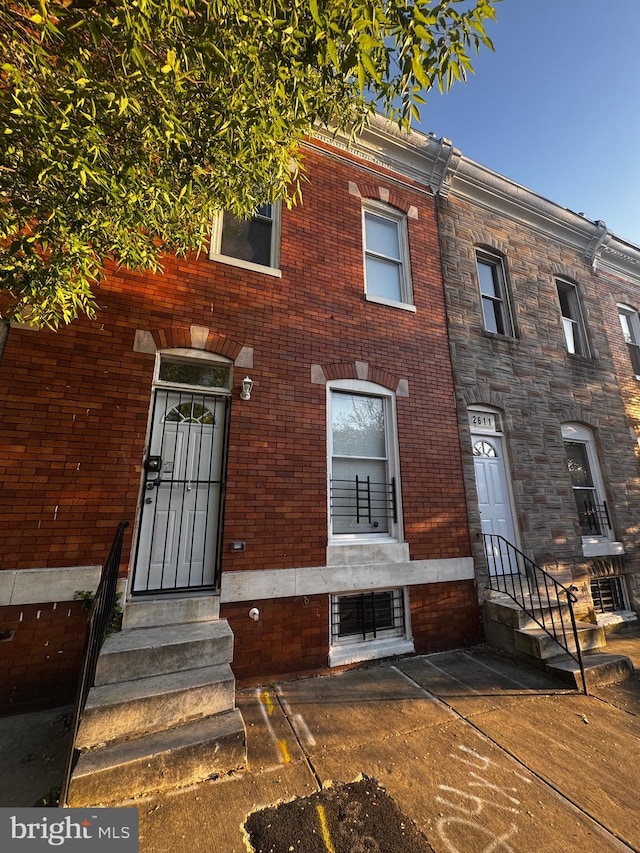 townhome / multi-family property with brick siding and entry steps