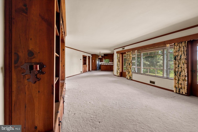 unfurnished room featuring carpet and baseboards