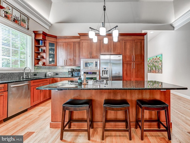 26 Bellchase Ct Unit B, Pikesville, MD 21208 - kitchen featuring stainless steel appliances, a breakfast bar, brown cabinets, a kitchen island, and open shelves