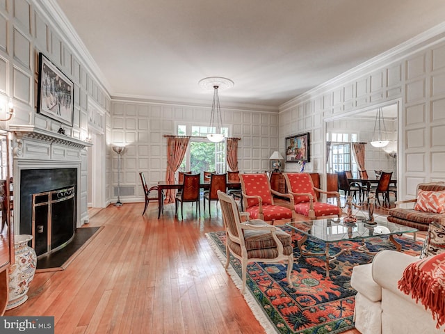 26 Bellchase Ct Unit B, Pikesville, MD 21208 - living room featuring a decorative wall, ornamental molding, a fireplace with raised hearth, and hardwood / wood-style floors