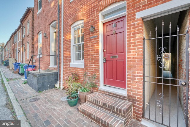 doorway to property with brick siding