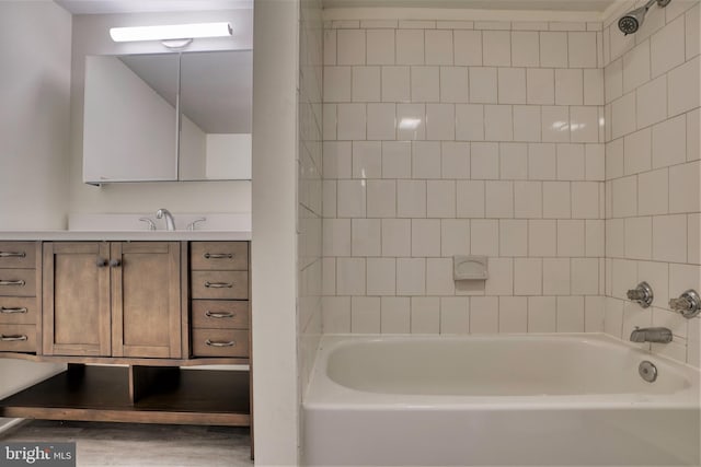 bathroom with vanity,  shower combination, and wood finished floors