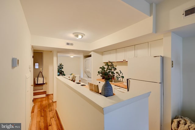 welcome area featuring stacked washer / dryer