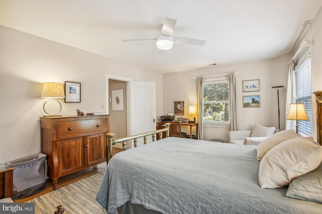 bedroom with multiple windows, light wood-type flooring, and ceiling fan