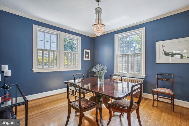 dining room with baseboards, ornamental molding, a healthy amount of sunlight, and a chandelier